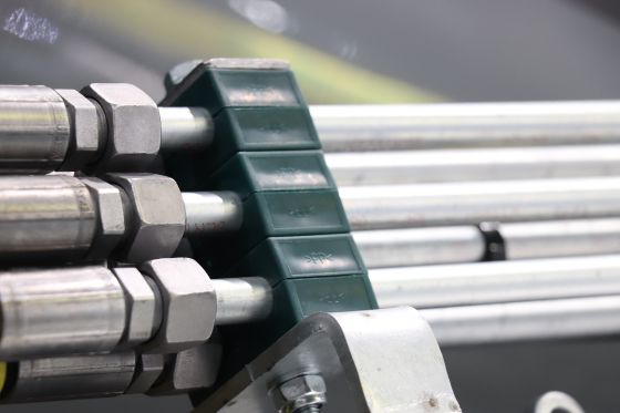 Several PP tube and pipe clamps from the STAUFF standard range mounted on top of each other