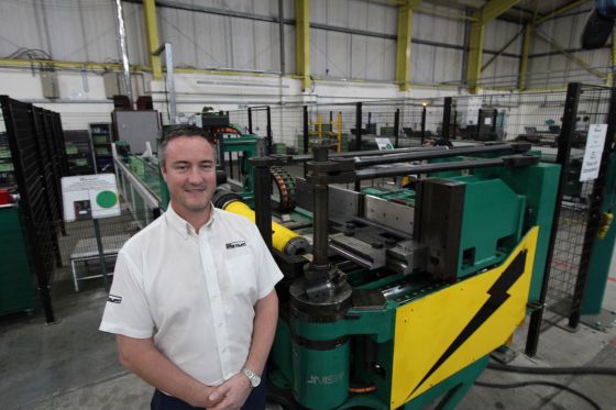 Ken Cleal standing next to STAUFF UK's flagship tube bender