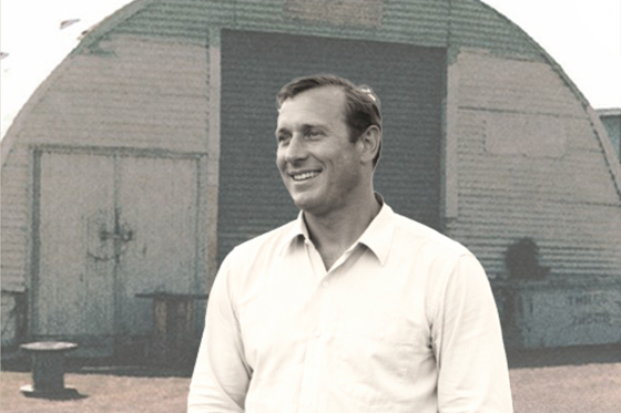 Arnold Menshen in front of a Nissen hut