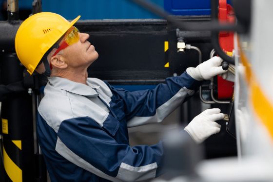 Man checks a hydraulic system