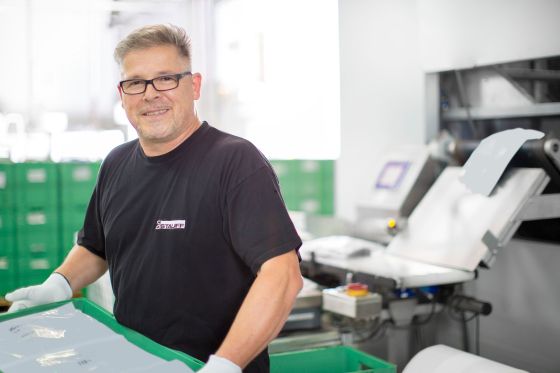 Employee packing an order of STAUFF clamps in sustainable bags