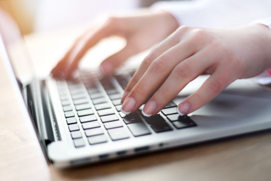 Someone is typing on a laptop